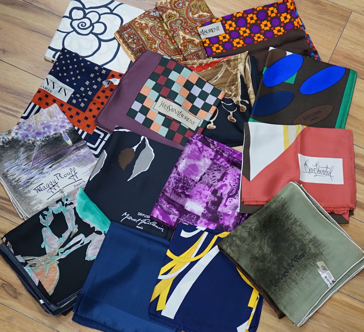 A collection of vintage silk scarves including Lanvin, Yves Saint Laurent, Maggy Rouff and one retailed by Harrods